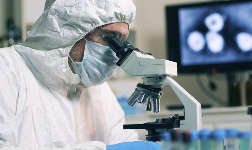 closeup lab tech with sample of Wuhan Coronavirus virus