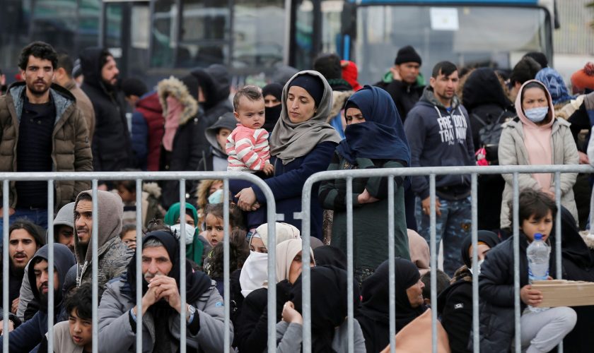 Migrants who arrived on the island of Lesbos in the past four days, are seen at the port of Mytilene, as they wait to board a Greek navy ship, in Mytilene