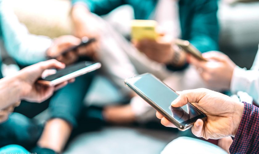 Close up of people using mobile smart phones – Detail of friends