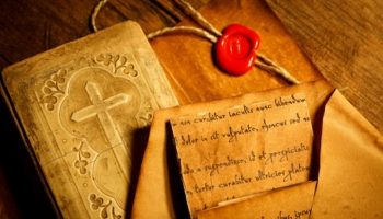 24533231-old-prayer-book-with-ancient-letters-wax-seal-stamp-in-the-background