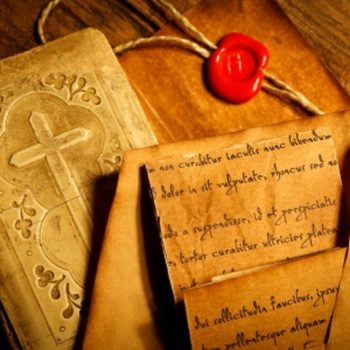 24533231-old-prayer-book-with-ancient-letters-wax-seal-stamp-in-the-background